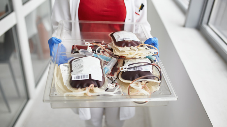 nurse carrying blood bags