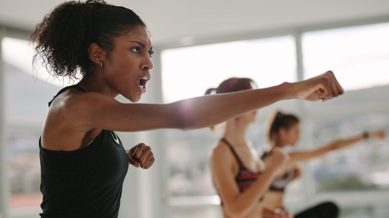 women doing punches during workout class