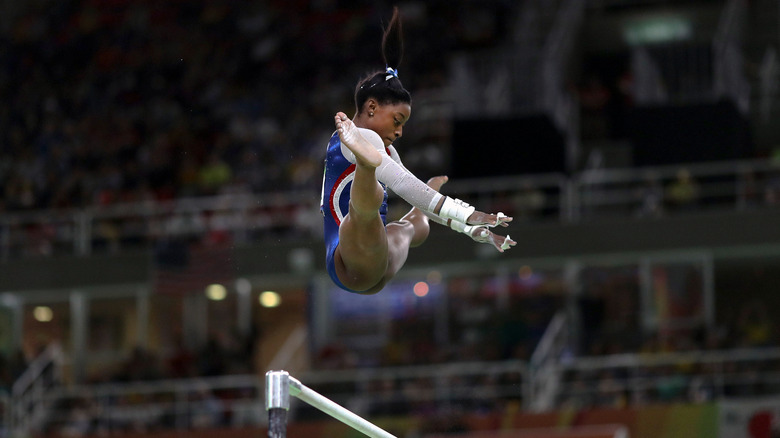 Simone Biles performing on the uneven bars