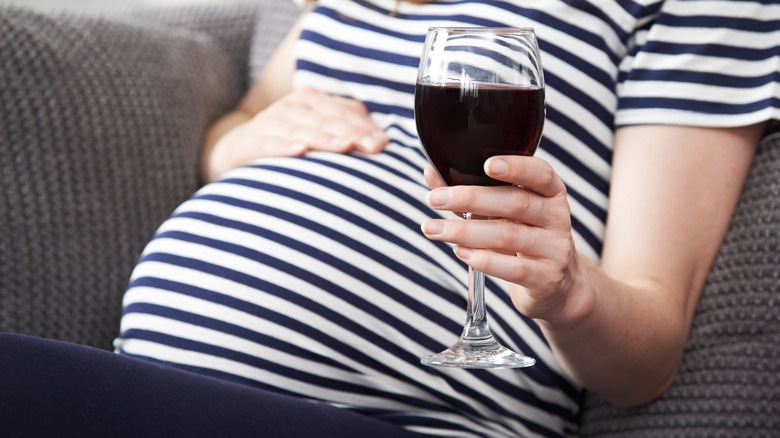 pregnant woman with a glass of wine