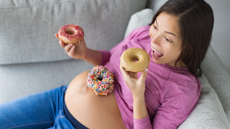 Pregnant Woman eating donuts