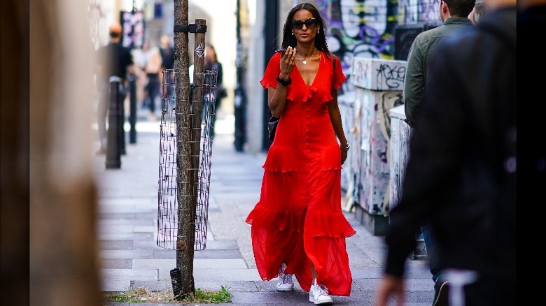 Woman wearing sneakers and maxi dress