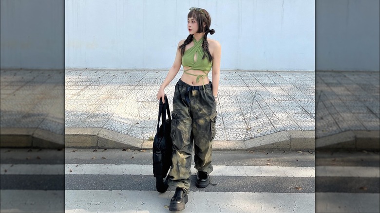 @laminee.99 wearing cargo pants and green halter top