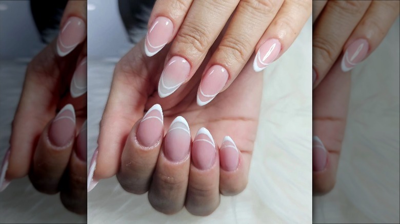 hands with white nail art