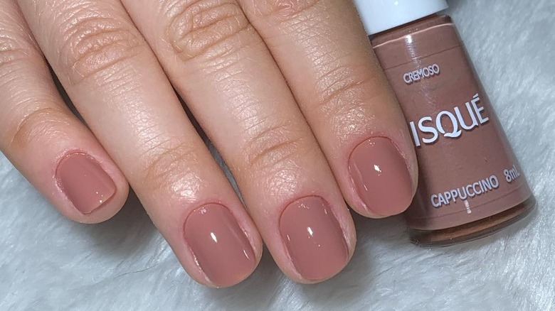 hand with light brown nail polish