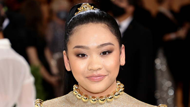 Suni Lee standing on the red carpet at the Met Gala