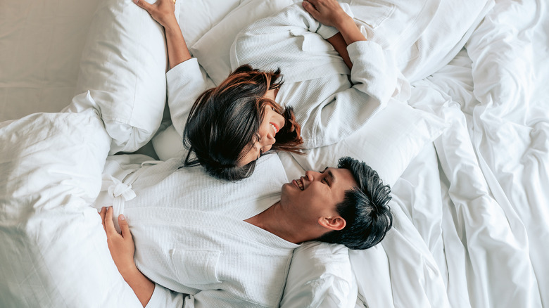 Couple smiling in bed