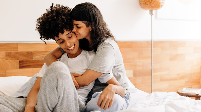 Couple embracing each other in bed