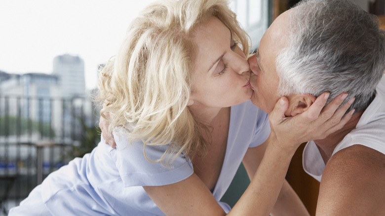 A couple kissing with background view