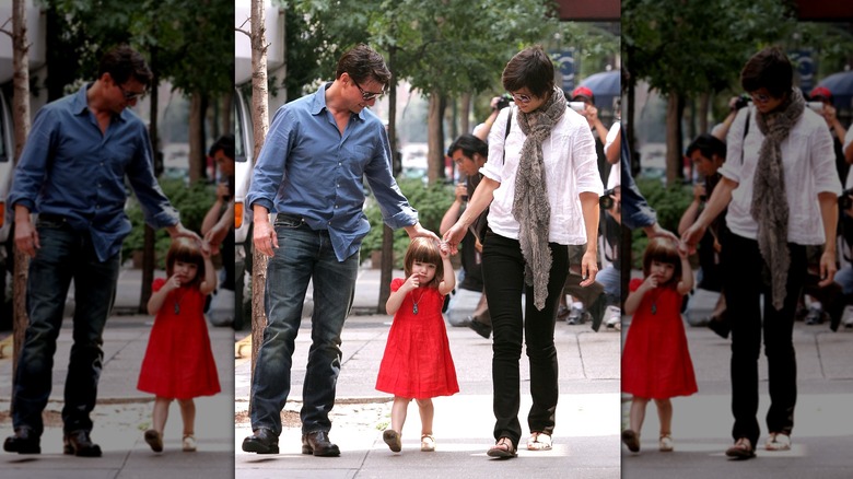 Tom Cruise and Katie Holmes with a young Suri