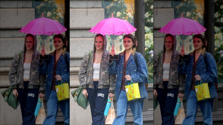 Suri Cruise walking outside with friend