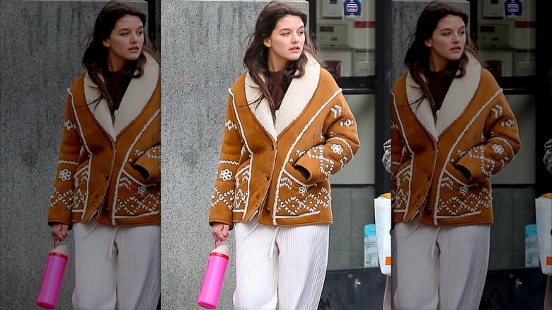 Suri Cruise walking, holding Owala bottle