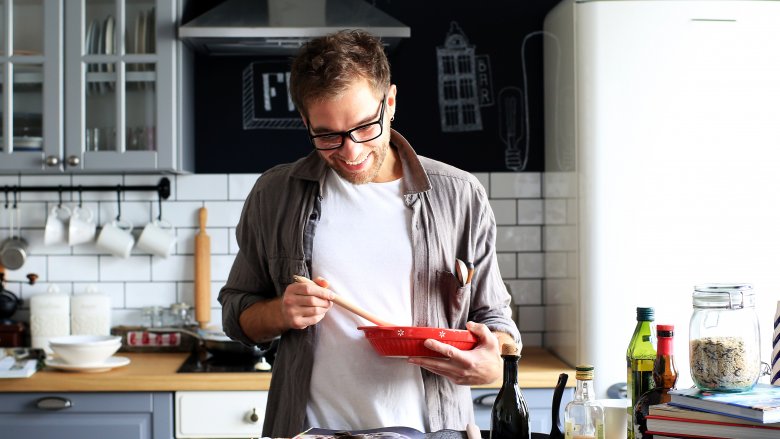 Attractive man cooking in kitchen