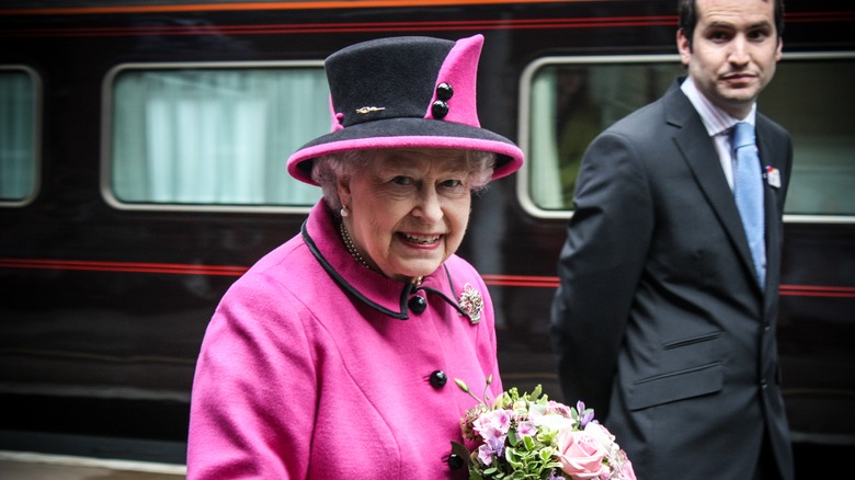 Queen Elizabeth smiling in pink