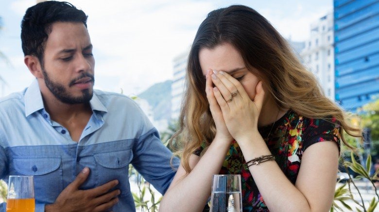 woman crying in front of man