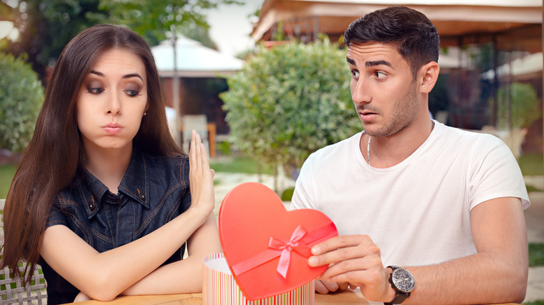 Woman refusing present from man