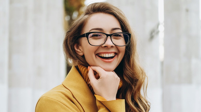 woman in glassses with hand under chin