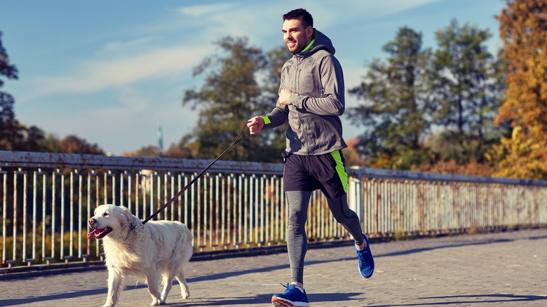 man jogging with dog