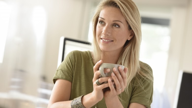 attractive mature woman holding coffee