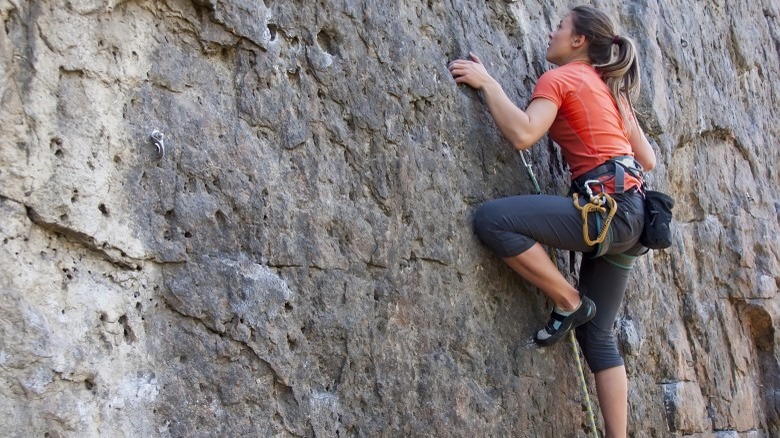 attractive woman rock climbing