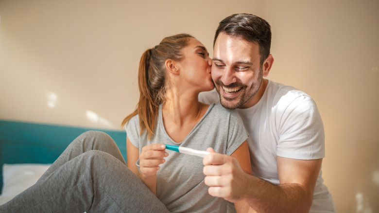 couple looking at a pregnancy test