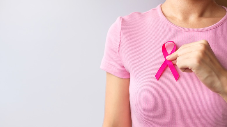 Woman holding breast cancer ribbon