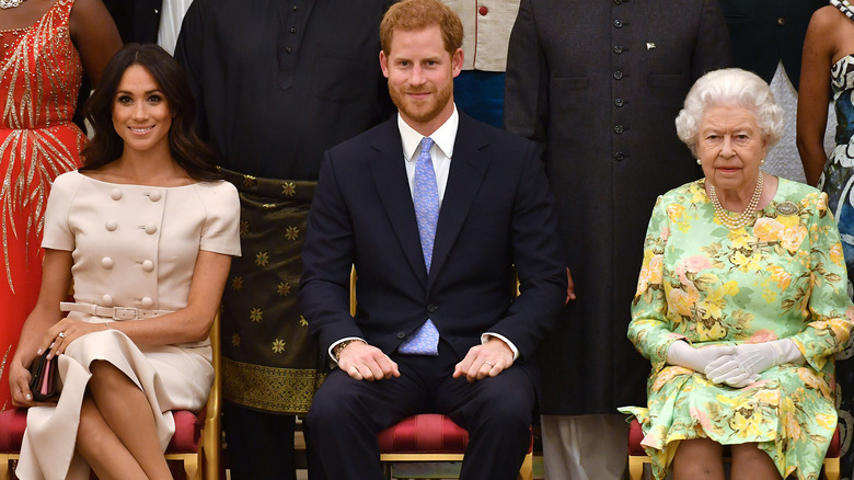 Meghan Markle, Prince Harry, Queen Elizabeth sitting 2018