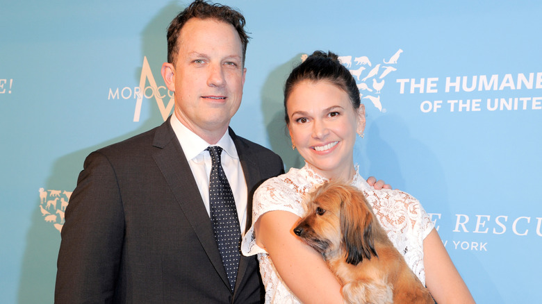 Ted Griffin and Sutton Foster holding a dog