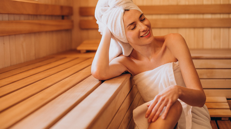 Woman relaxing in a sauna