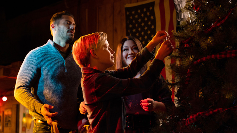 Cast decorating a tree in A Country Christmas Harmony