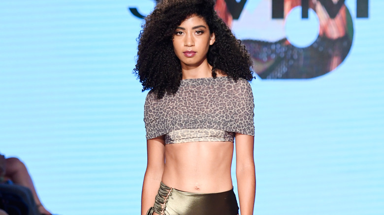 Woman modeling an animal print swimsuit