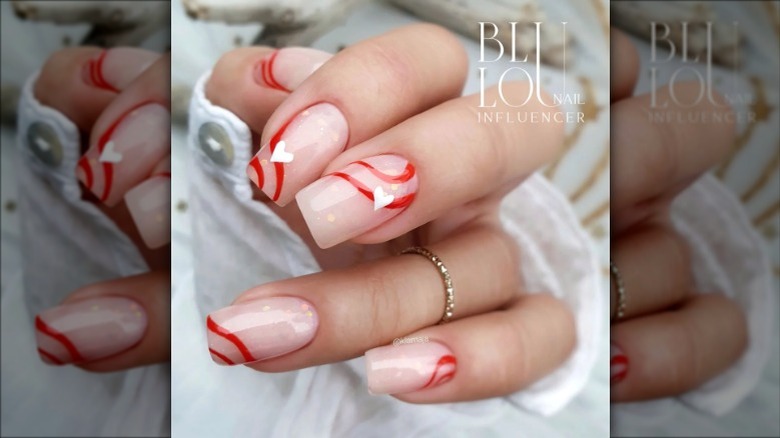 Nude and red heart swirl nails