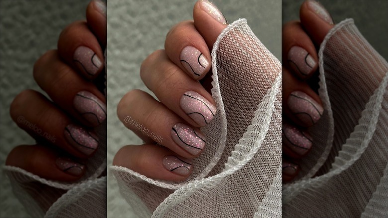 Glittery pink and black swirl nails