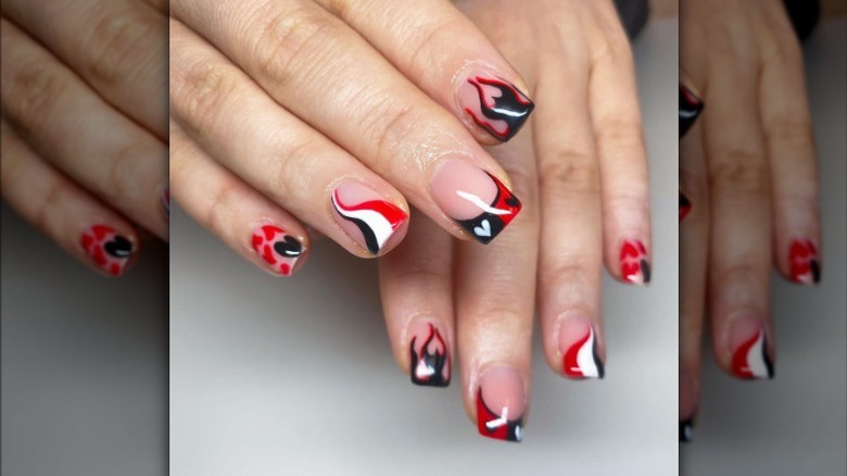 Red, black, and white swirl nails