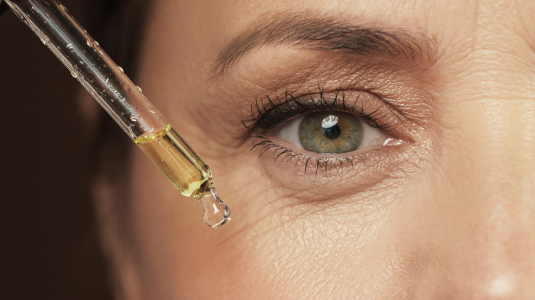 Woman using an eye serum