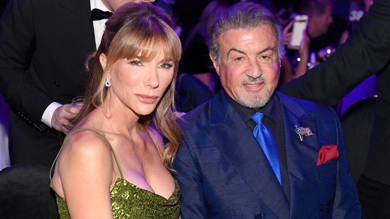 Jennifer Flavin and Sylvester Stallone smirking