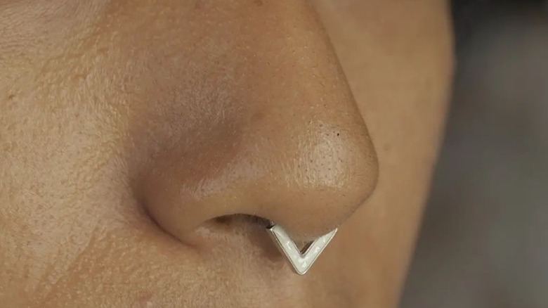 Woman with a diamond chevron septum piercing 