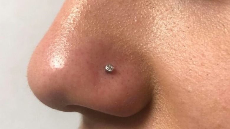 Woman with a small diamond nose stud in nostril 