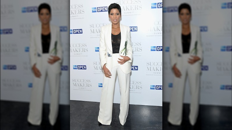 Tamron Hall posing in white jumpsuit