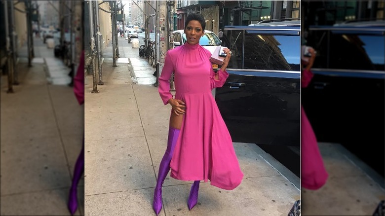 Tamron Hall posing in pink, purple