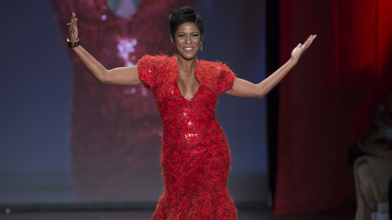 Tamron Hall modeling red gown