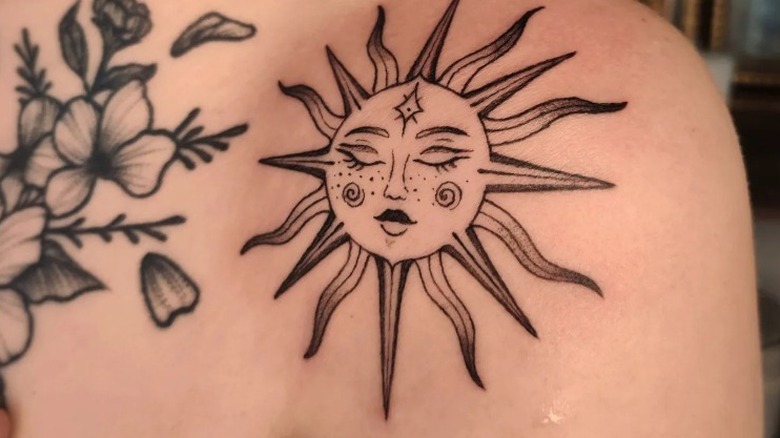 A sun tattoo on shoulder