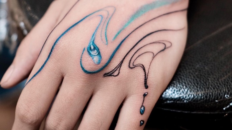 Water droplet tattoo on hand