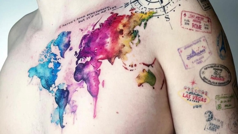 Tattoo of world map and travel stamps