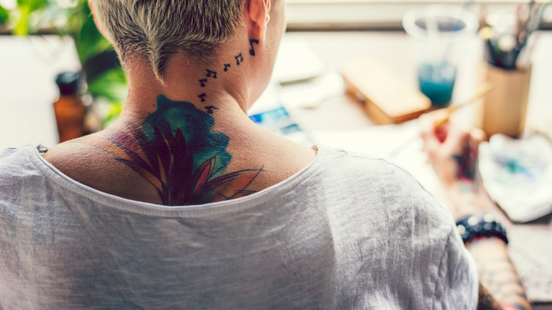 woman with watercolor tattoo on neck