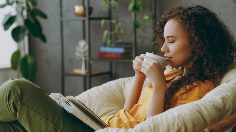 Woman relaxing with a book and tea