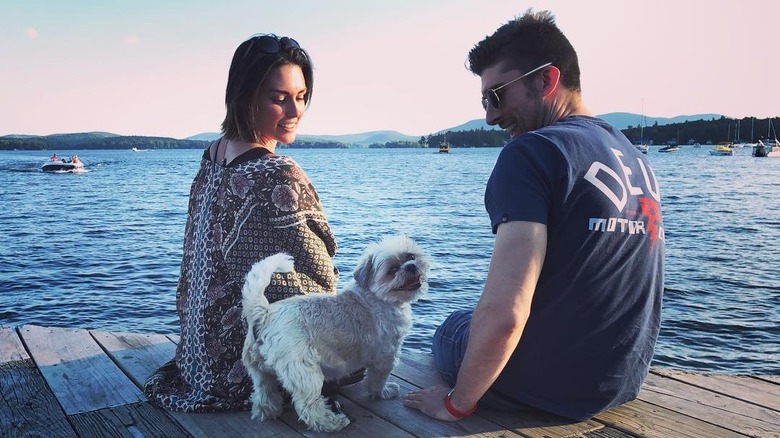 Taylor Cole sitting next to her husband and dog