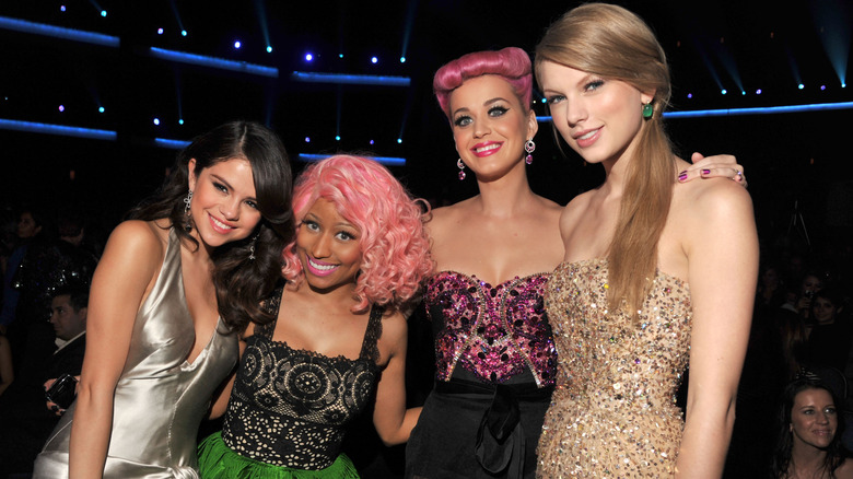 Taylor Swift and Katy Perry smiling with Nicki Minaj and Selena Gomez