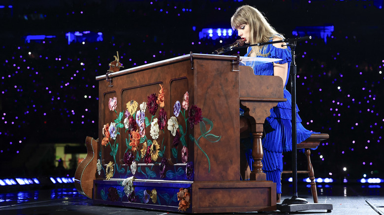 Taylor Swift performing at the piano on the Eras Tour