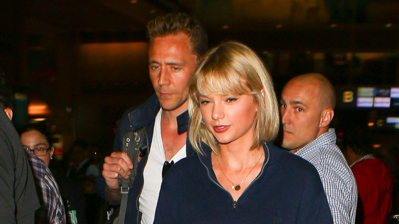 Taylor Swift and Tom Hiddleston walking together